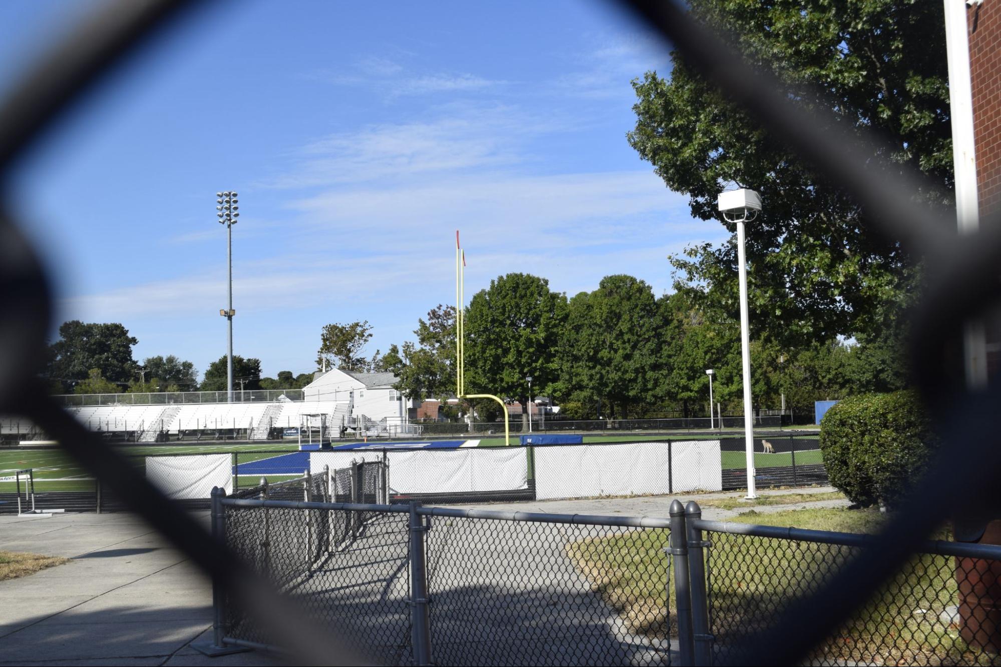 A photo of Norview High Schools football field, through a fence
