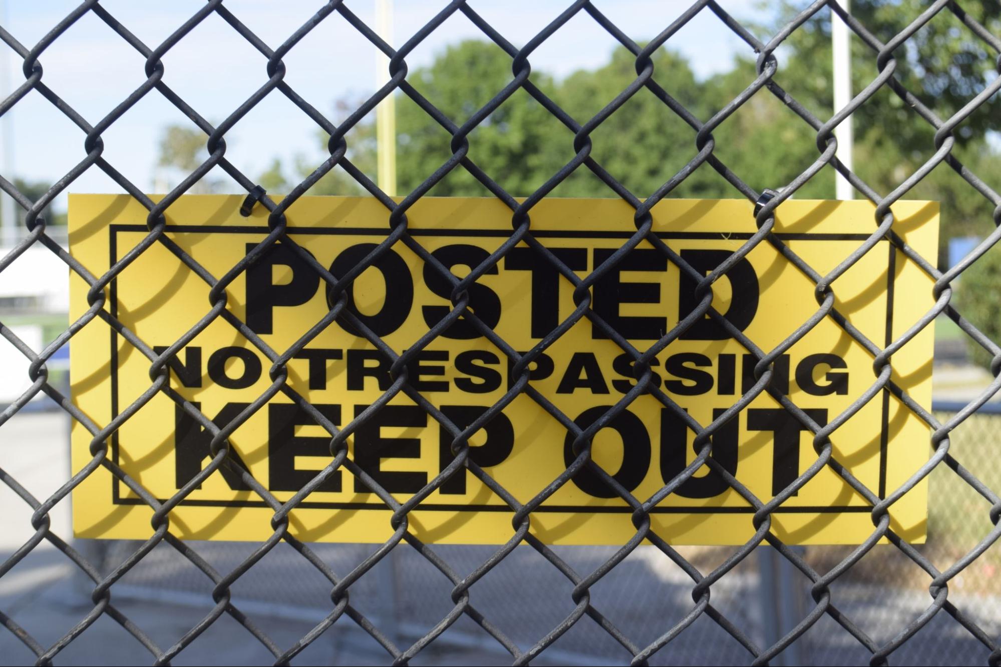 A sign that reads 'POSTED NO TRESPASSING KEEP OUT'